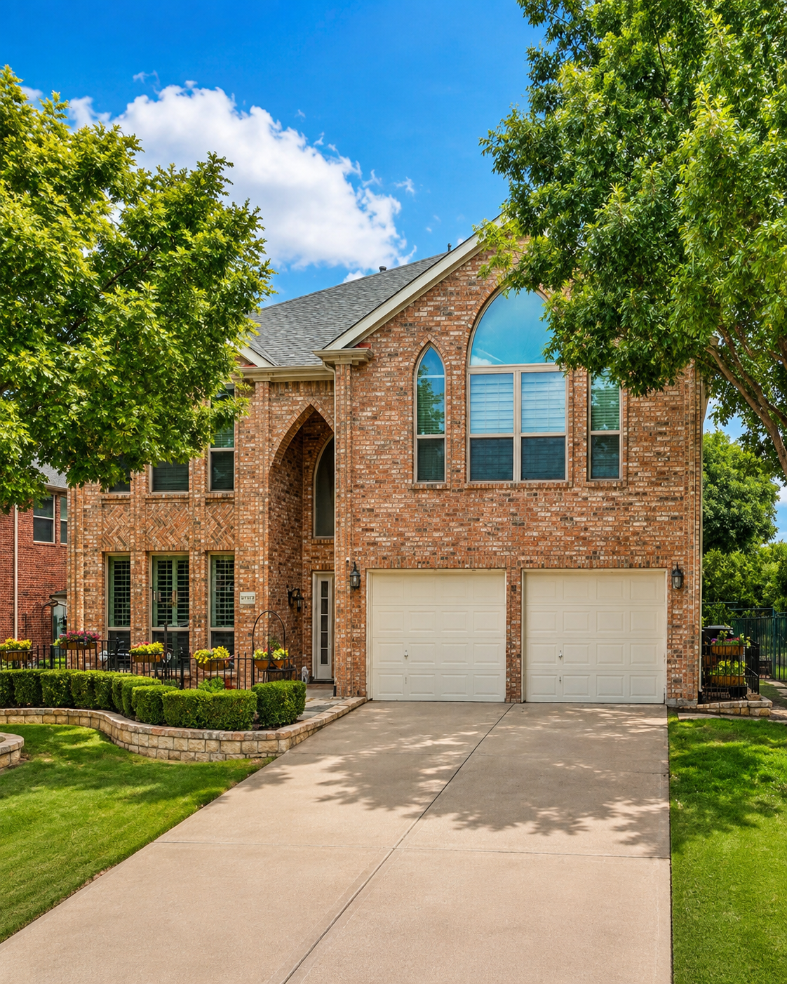 Two-story brick home with arched windows