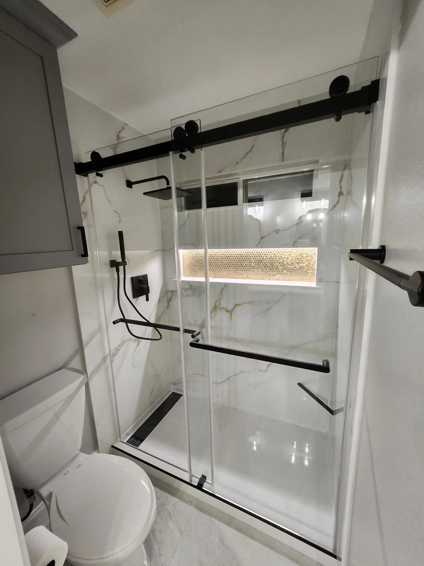 Completed custom walk-in shower remodel with glass and premium wall system