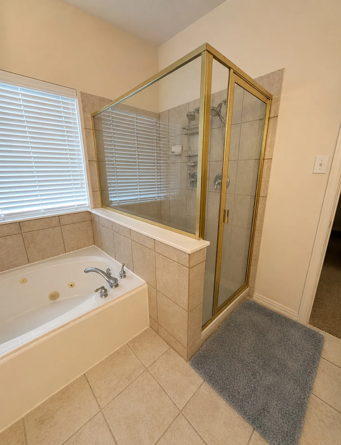 Builder-grade shower before custom remodel