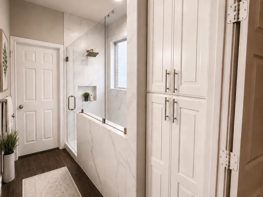 Custom bathroom storage beside glass shower