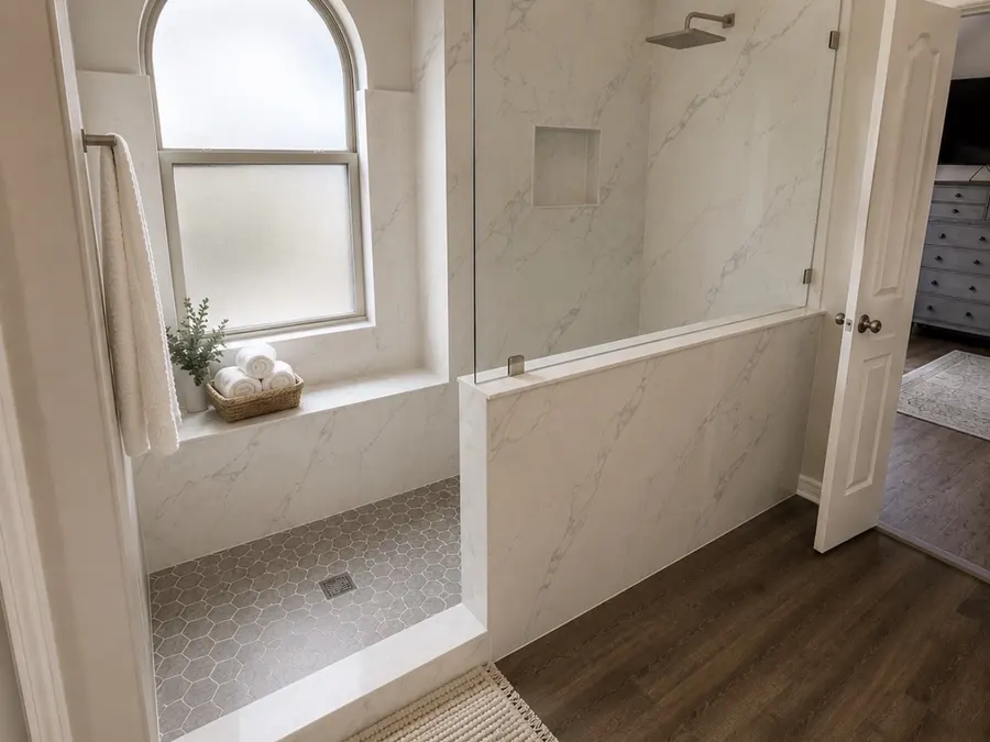 Custom walk-in shower with arched window and built-in bench